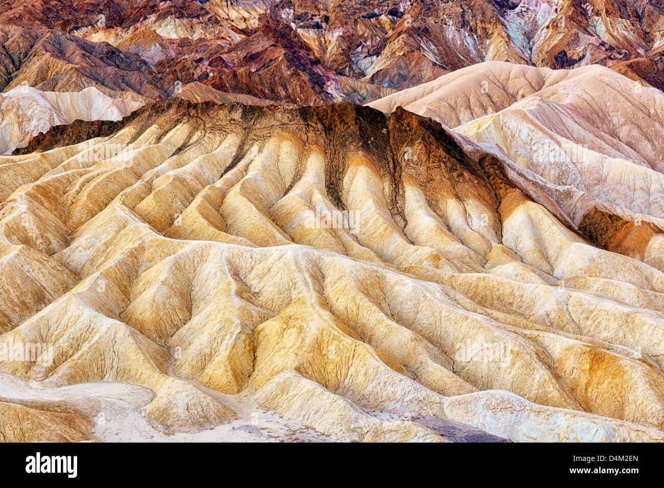 Civil twilight bathes the multi colors of Golden Canyon Badlands in California's Death Valley National Park. Stock Photo