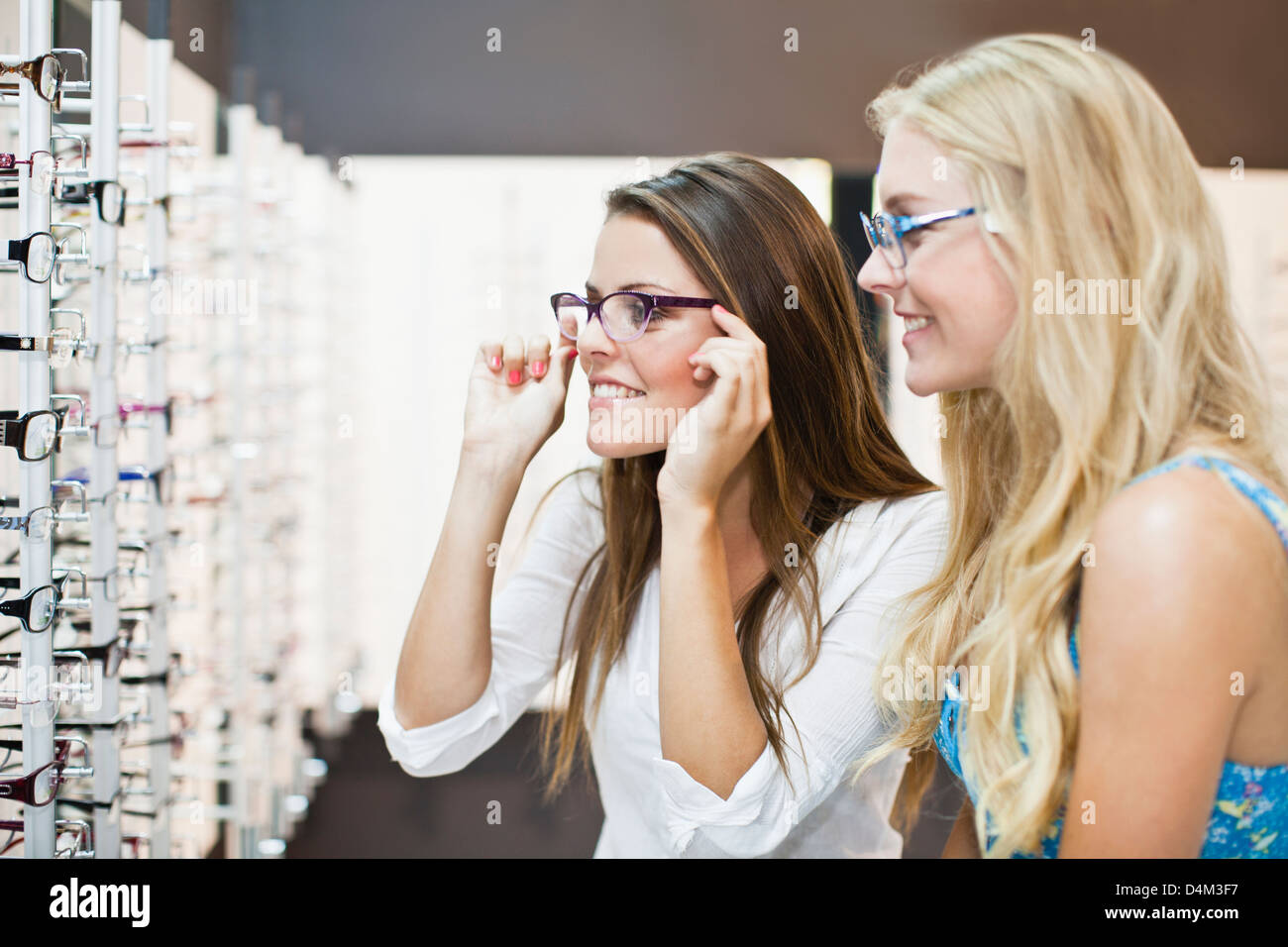 Women trying on glasses in store Stock Photo Alamy