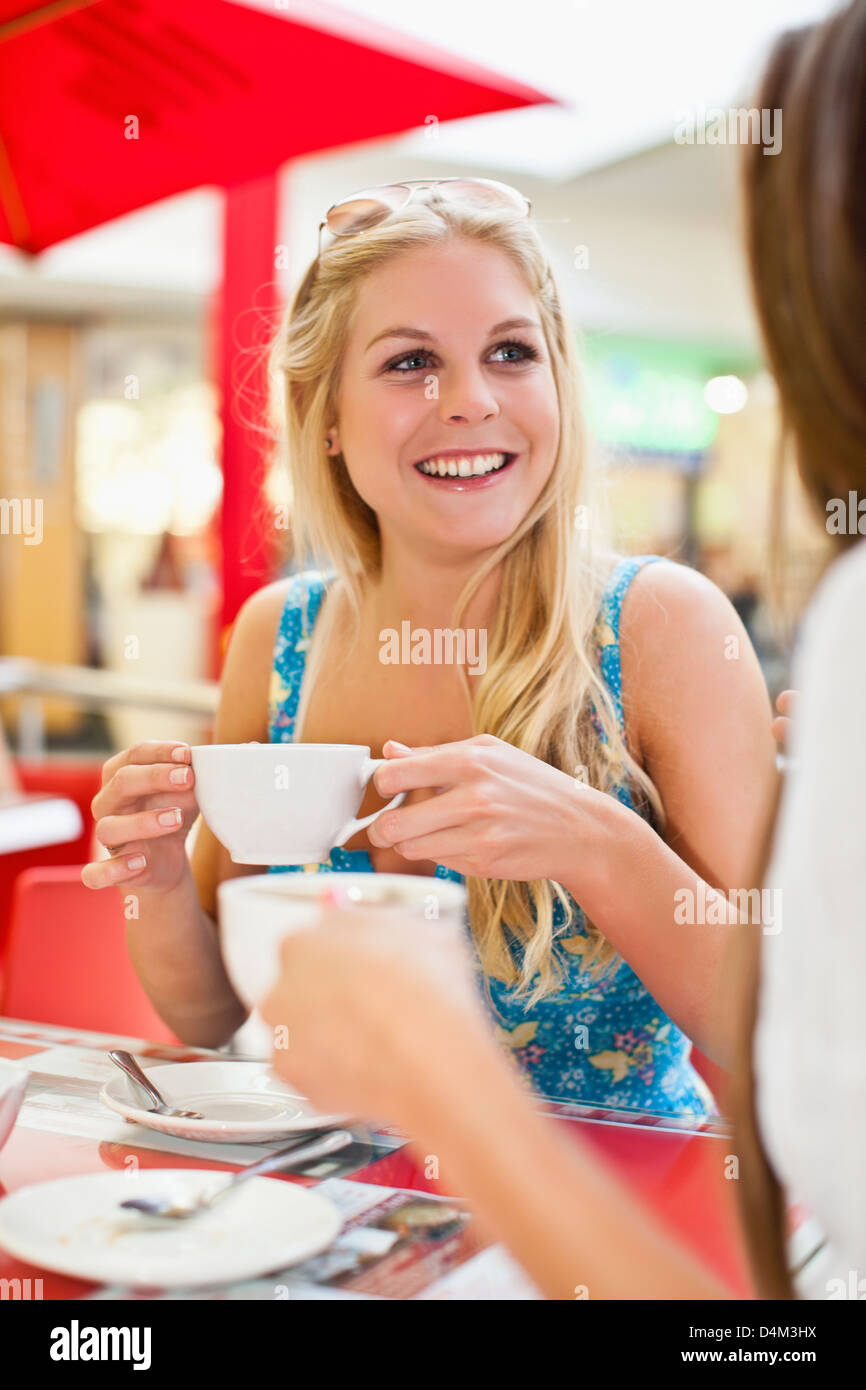 Women having coffee at sidewalk cafe Stock Photo - Alamy