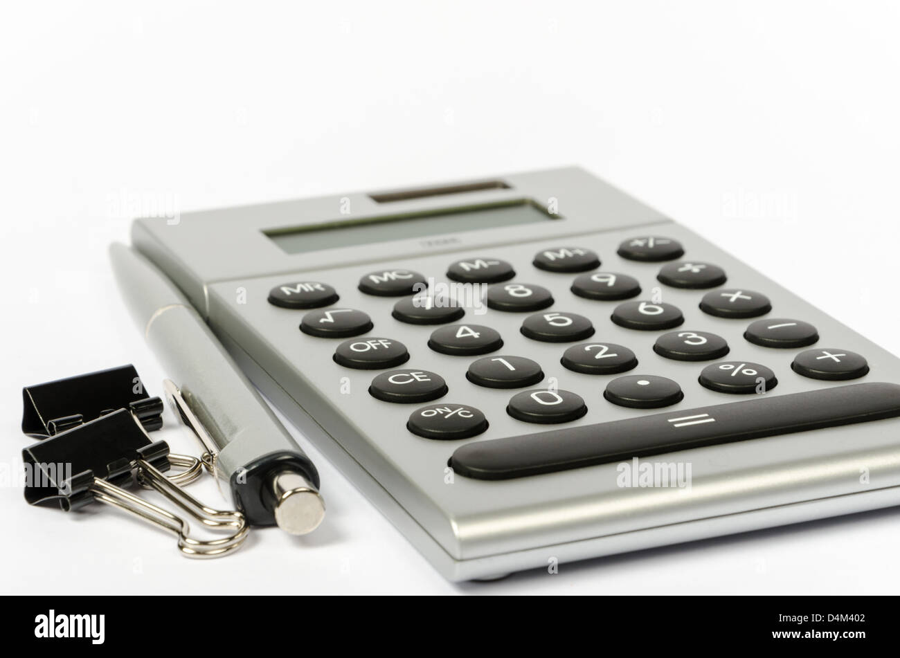 Paper clips, a calculator and a pen on a white background Stock Photo ...