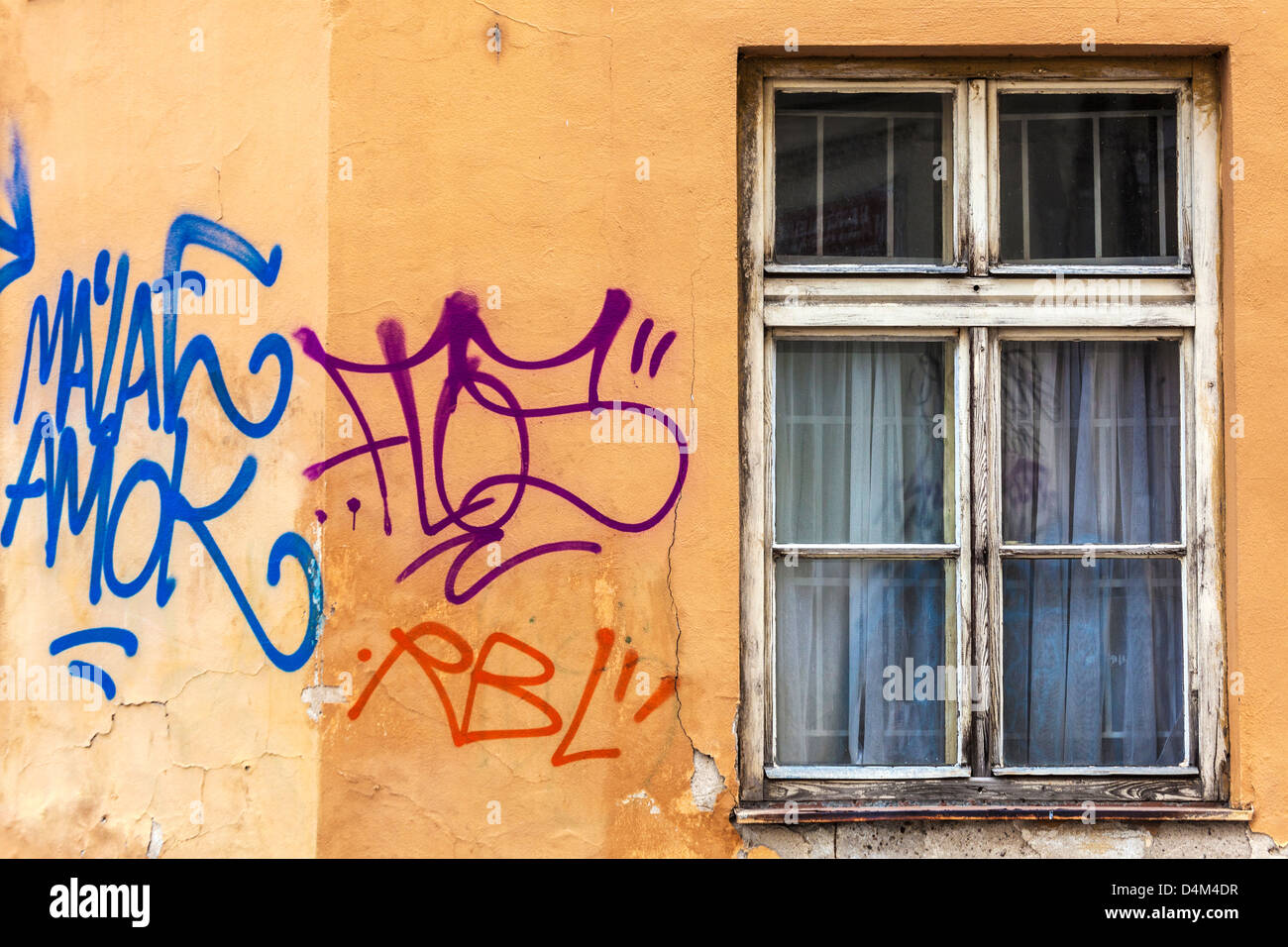 Graffiti on a plastered wall by an old decaying window in a small side street in old town Prague, Praha, Czech Republic Stock Photo