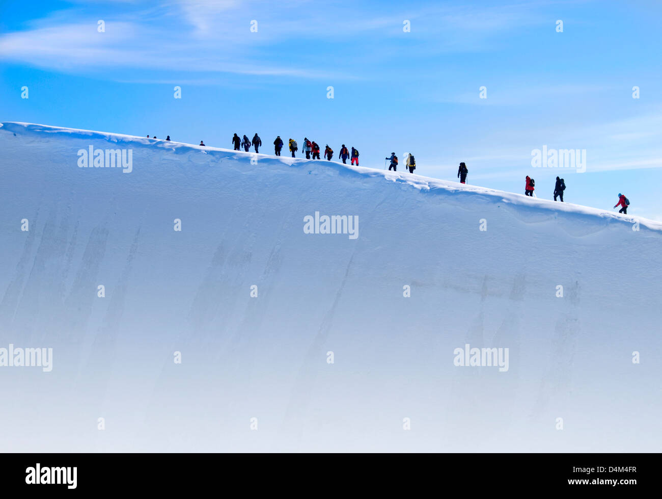 Expedition team members hiking on a glacier at Charlotte Bay in Antarctica Stock Photo