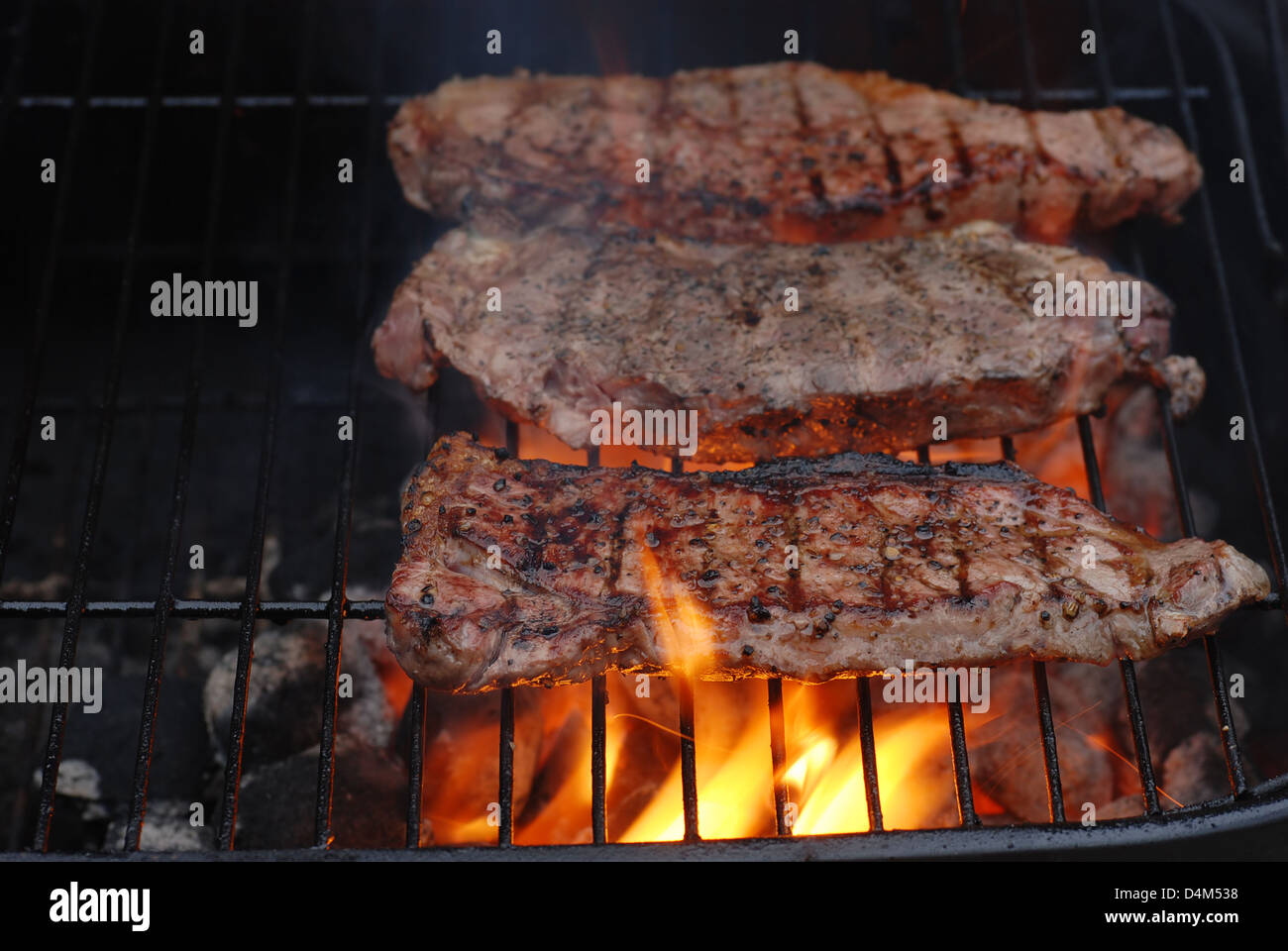Strip loin steaks on the barbecue Stock Photo Alamy