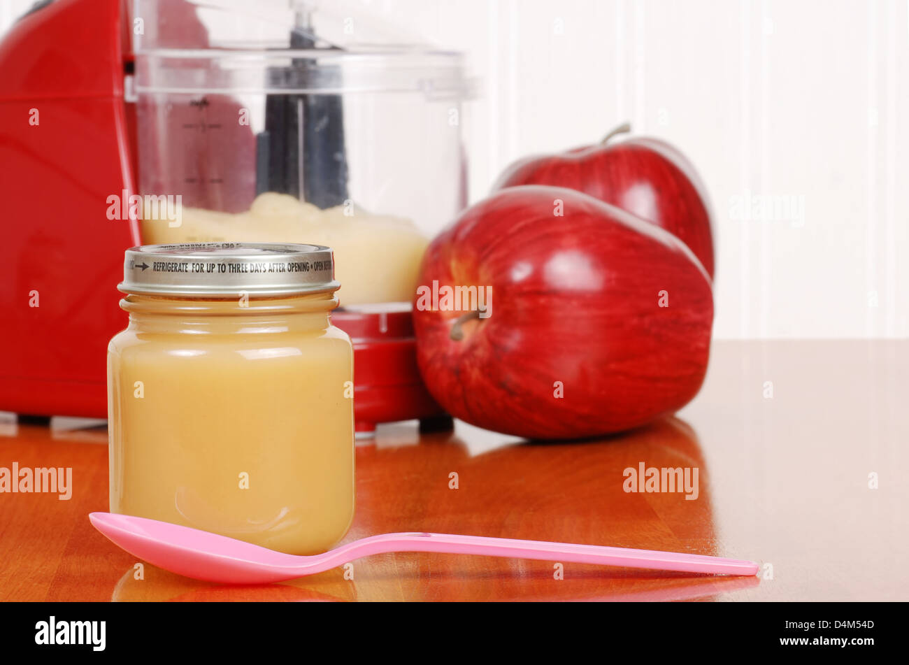 homemade apple sauce baby food with spoon Stock Photo
