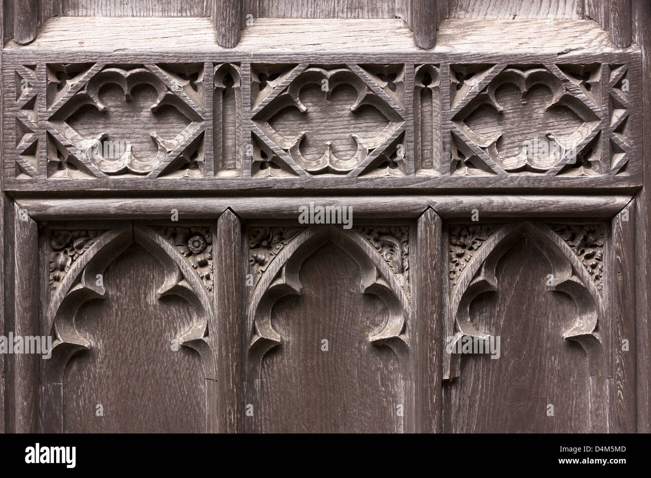 Detail of old Gothic carved oak wood church door, St Martin's Church, Stamford, Lincolnshire, England, UK Stock Photo