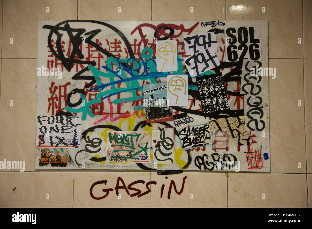Heavily grafittied restroom wall in a Chinese restaurant in Chinatown