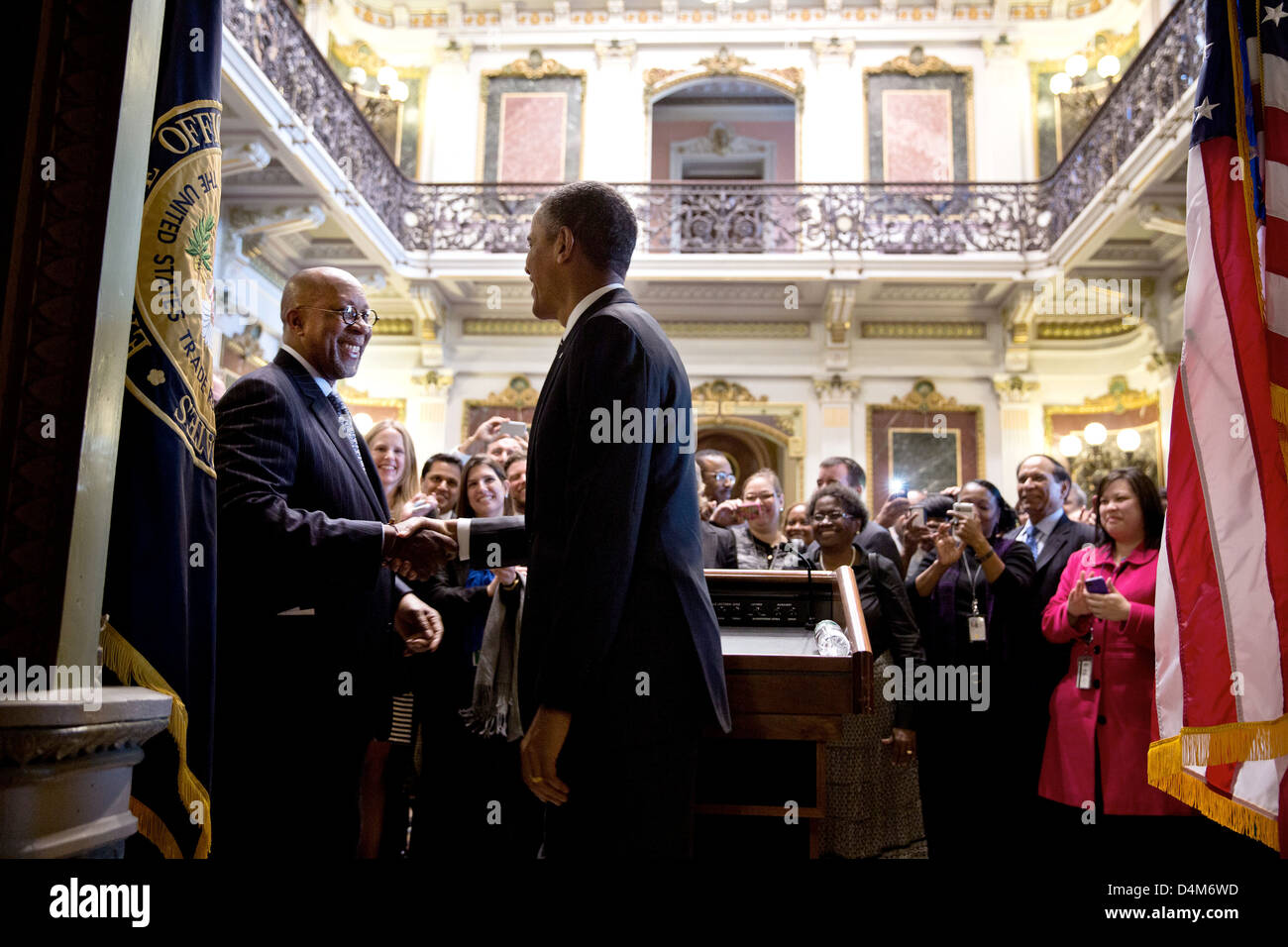 US President Barack Obama drops by a farewell reception for US Trade Representative Ron Kirk in the Indian Treaty Room of the Eisenhower Executive Office Building at the White House February 25, 2013 in Washington, DC. Stock Photo