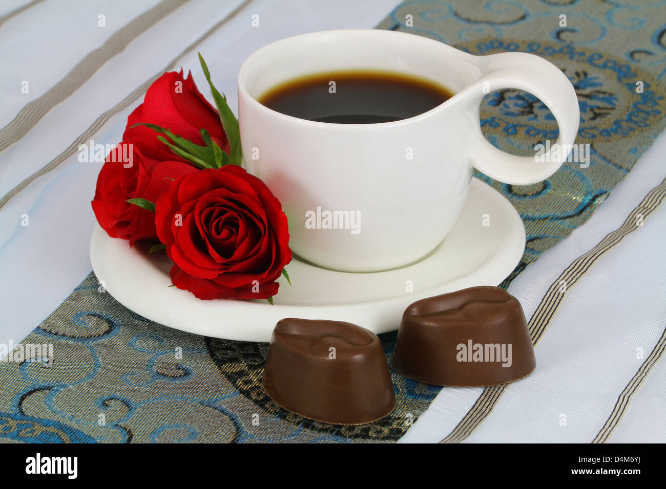 Cup of coffee, red roses and milky chocolates Stock Photo Alamy