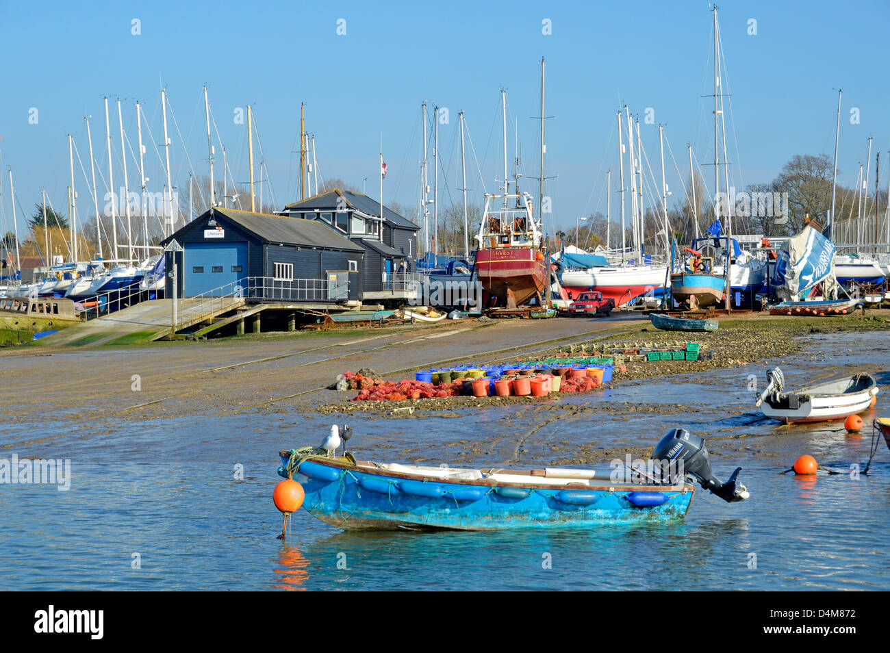West Mersea lifeboat station buildings and boat yards landscape along the River Blackwater waterfront Mersea Island near Colchester Essex England UK Stock Photo