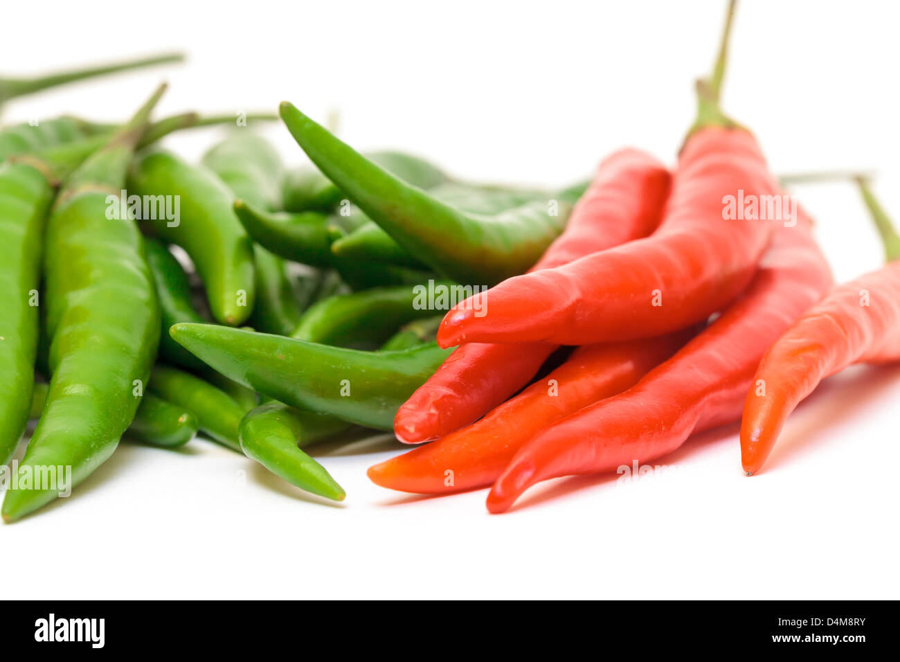 Heap Red and Green Chilli Hot Peppers closeup on white background Stock Photo