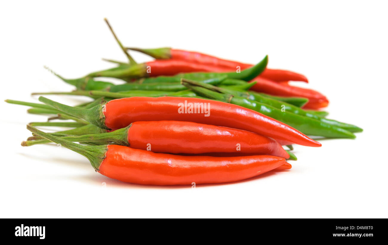 Heap Red and Green Chilli Hot Peppers on white background Stock Photo