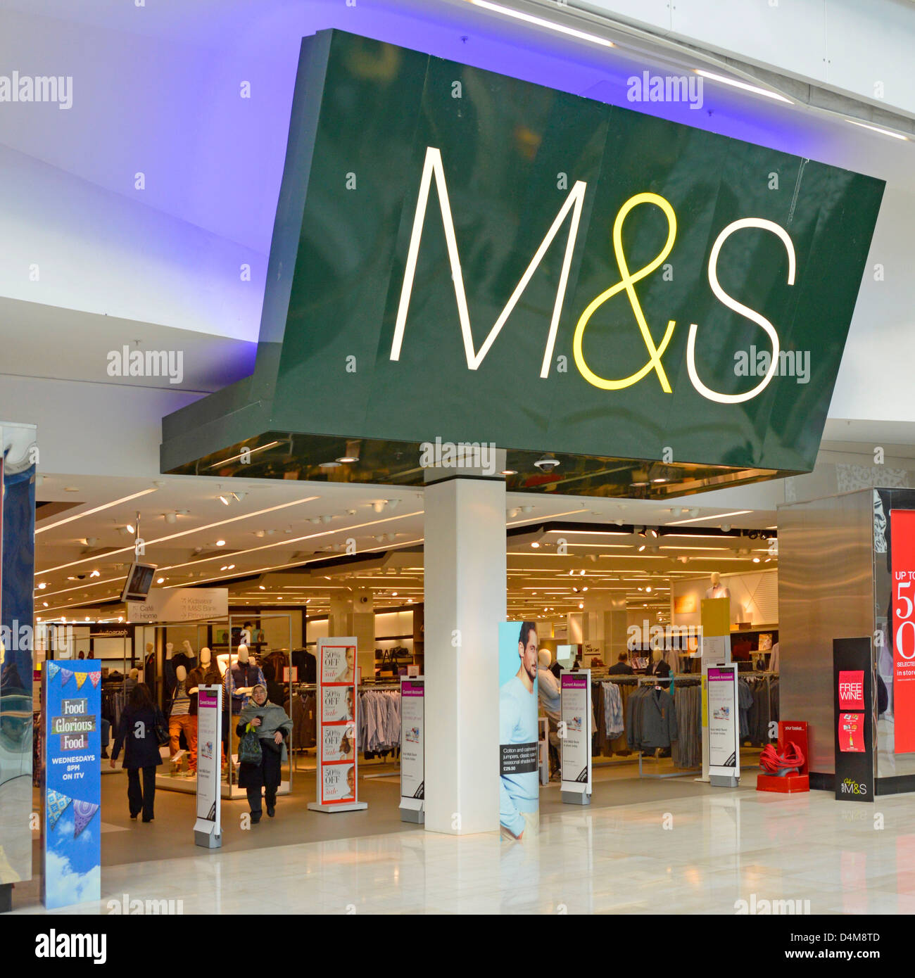 Entrance to M&S store at the Westfield centre indoor shopping malls with large logo sign above at White City Shepherds Bush West London England UK Stock Photo