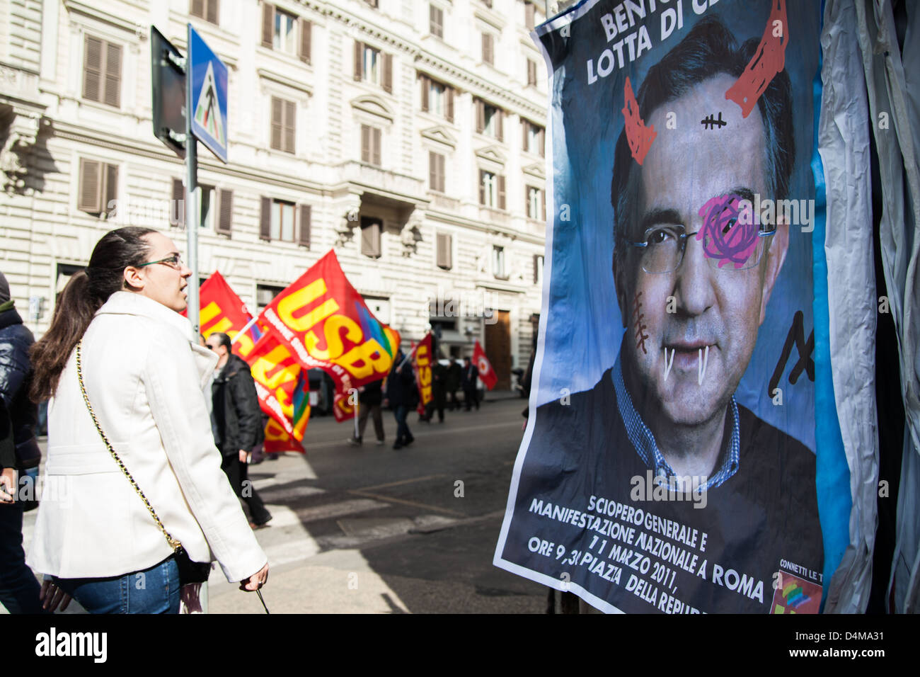 A woman looks at a banner of CEO of FIAT corp. Sergio Marchionne, during a general strike demonstration Stock Photo