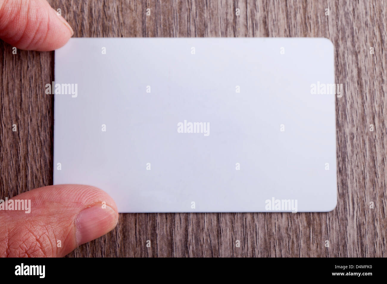 Male hand near a white business card Stock Photo