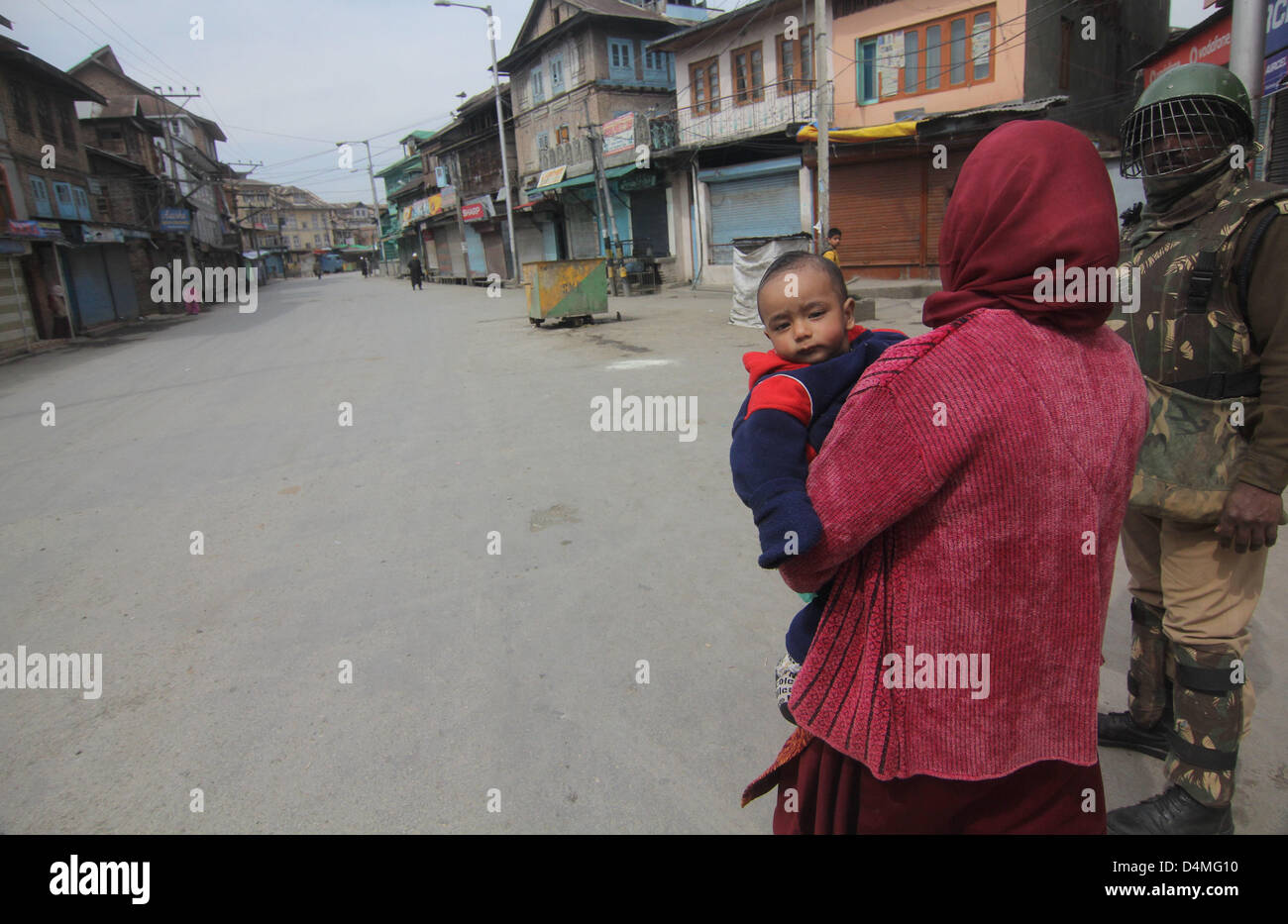 March 16, 2013 - A kasmiri muslim women walks with her child during  curfew at old city  in srinagar, the summer capital of indian kashmir , on 16/3/2013,Curfew was imposed on Thursday after a 34-year-old youth was killed when Indian paramilitary soldiers  allegedly opened fire after coming under attack by a group of stone pelters in the Zoonimar area..Photo/Altaf Zargar/Zuam Press (Credit Image: © Altaf Zargar/ZUMAPRESS.com) Stock Photo