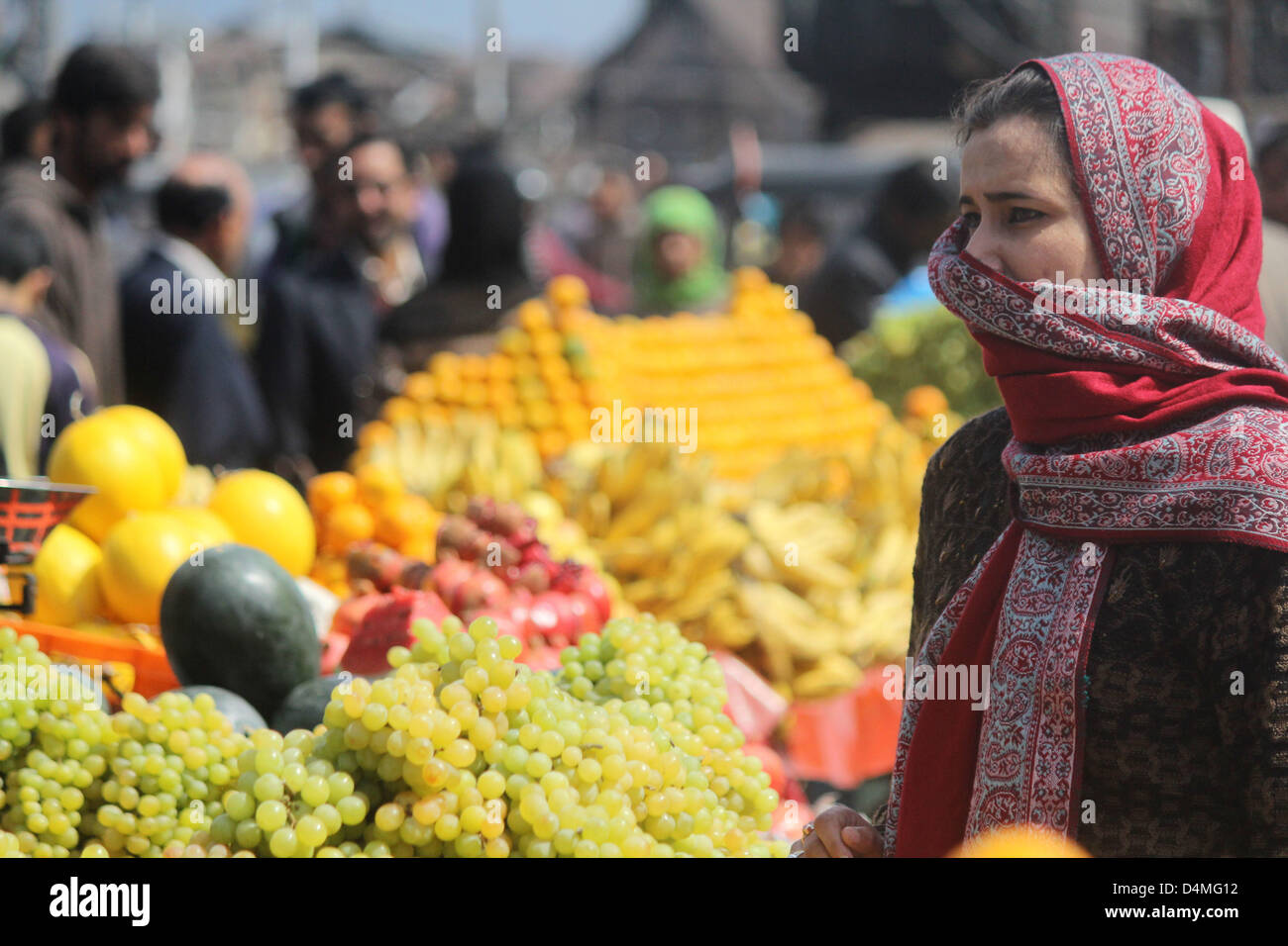 March 16, 2013 - A kasmiri muslim women Buying  fruits at a market  after the  Releaxation of curfew in srinagar, the summer capital of indian kashmir , on 16/3/2013,Curfew was imposed on Thursday after a 34-year-old youth was killed when Indian paramilitary soldiers   allegedly opened fire after coming under attack by a group of stone pelters in the Zoonimar area..Photo/Altaf Zargar/Zuam Press (Credit Image: © Altaf Zargar/ZUMAPRESS.com) Stock Photo
