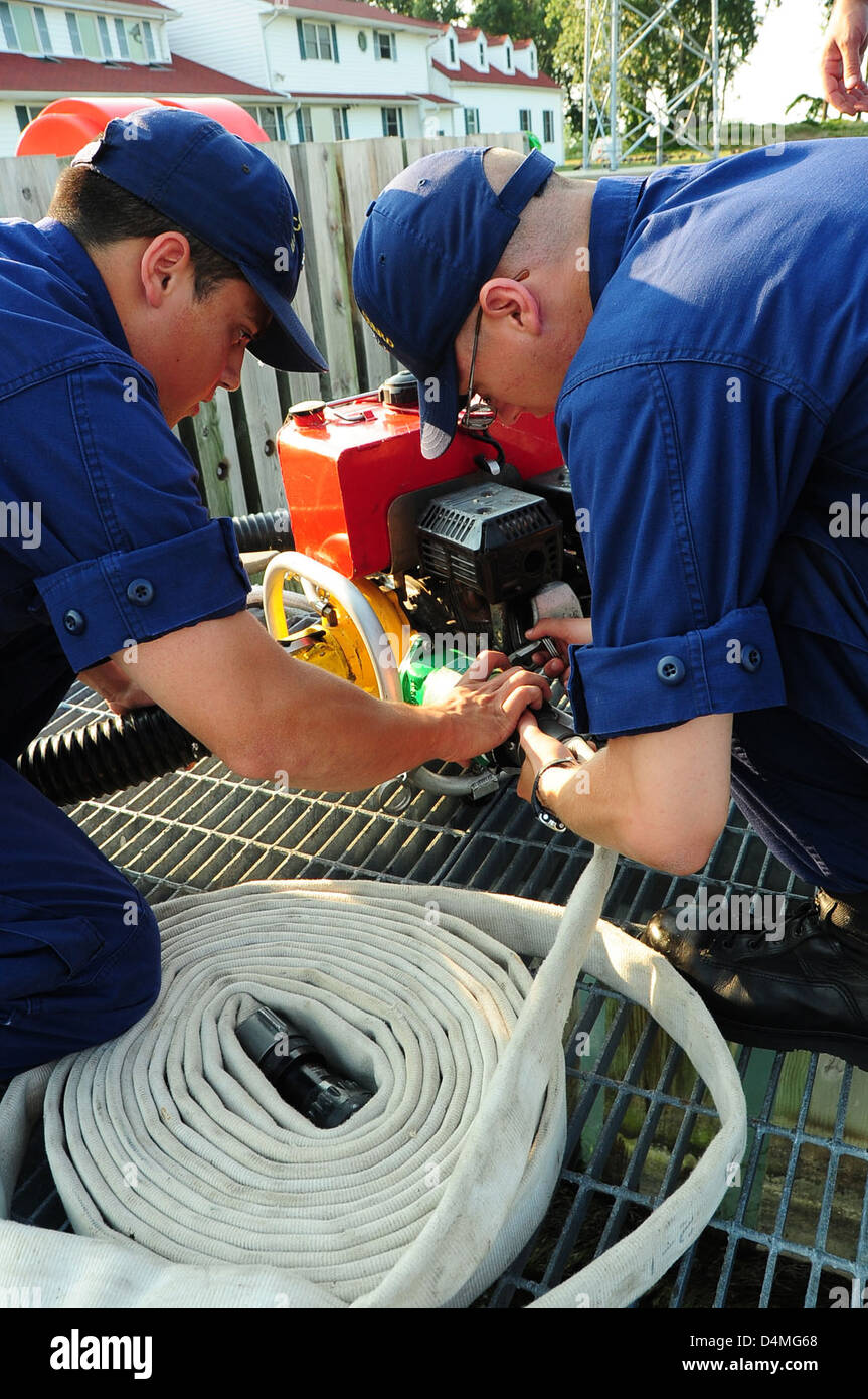 During U.S. Coast Guard Week, a break-in training exercise is held to simulate various scenarios that Coast Guard personnel may face. The training prepares them for critical situations, ensuring they are equipped to handle real-life emergencies. Stock Photo