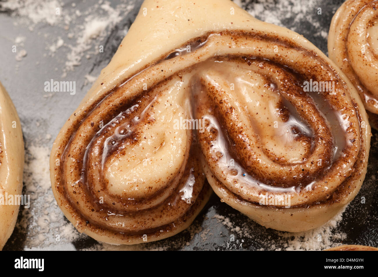 Cinnamon buns ready for baking on a cookie sheet Stock Photo