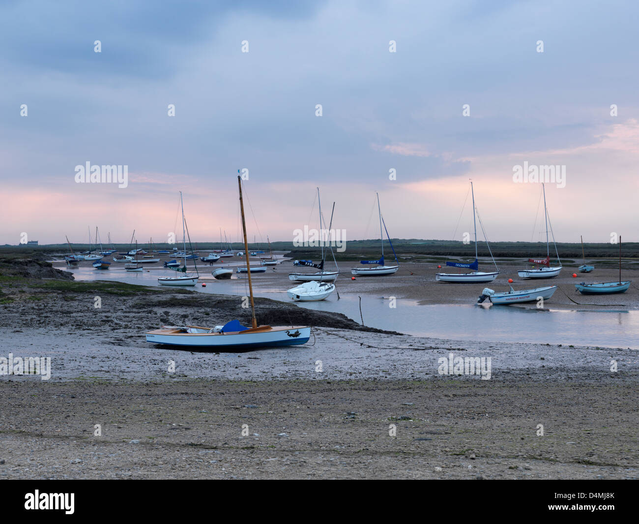 Low tide under a stormy sky at Brancaster Staithe, Norfolk, England Stock Photo