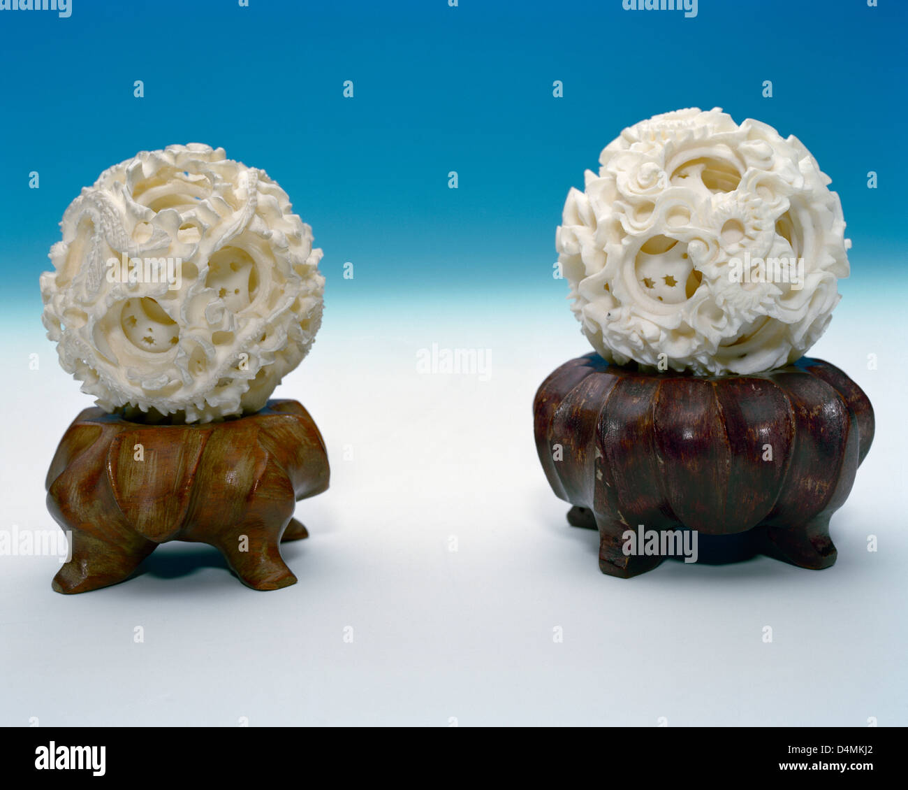 Chinese carved ivory concentric balls on rosewood stands Stock Photo