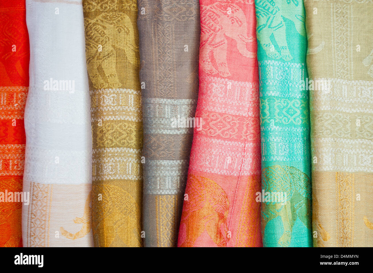 The heap of Thai traditional pattern silk cloth fabrics. Stock Photo