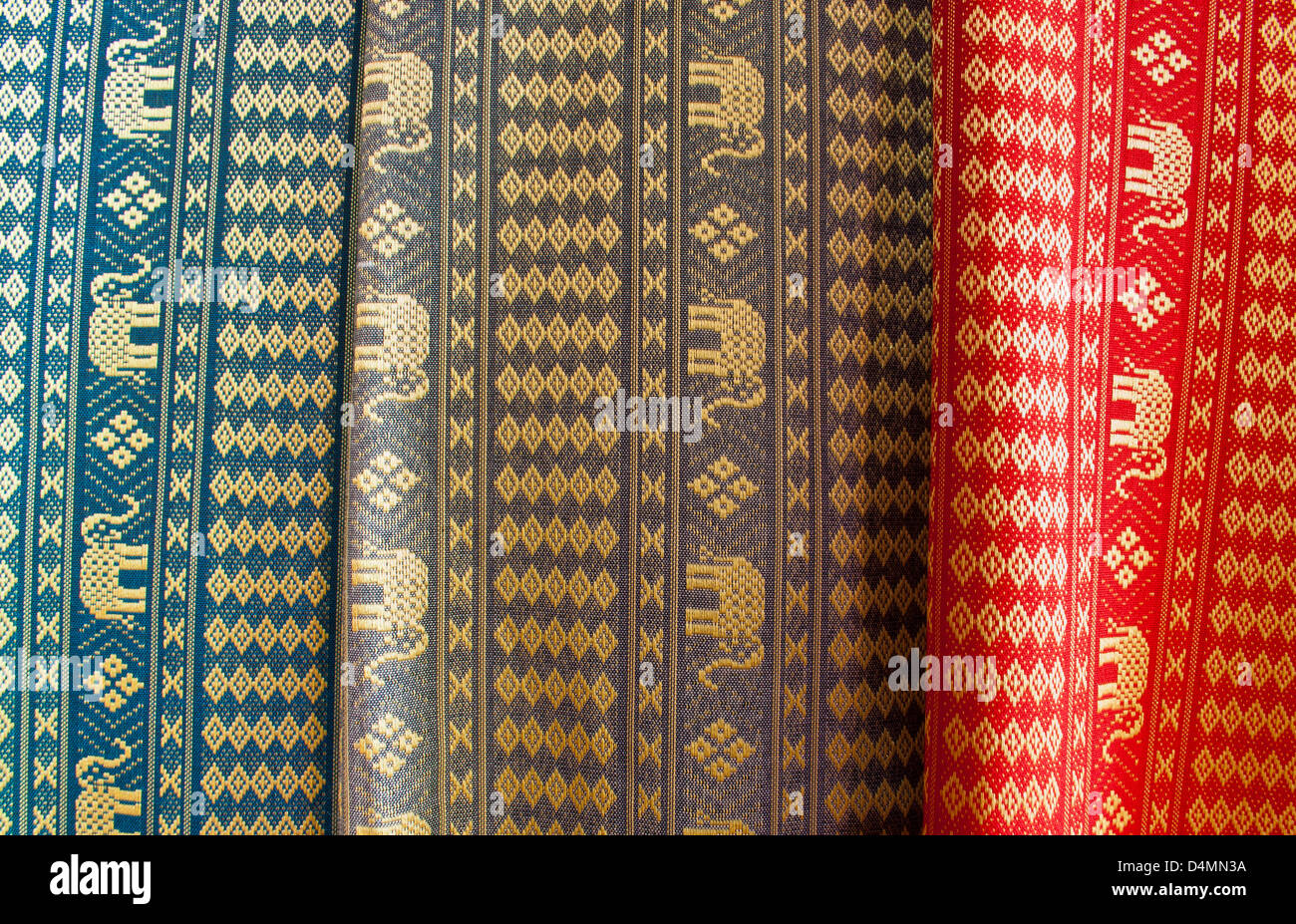 The heap of Thai traditional pattern silk cloth fabrics. Stock Photo