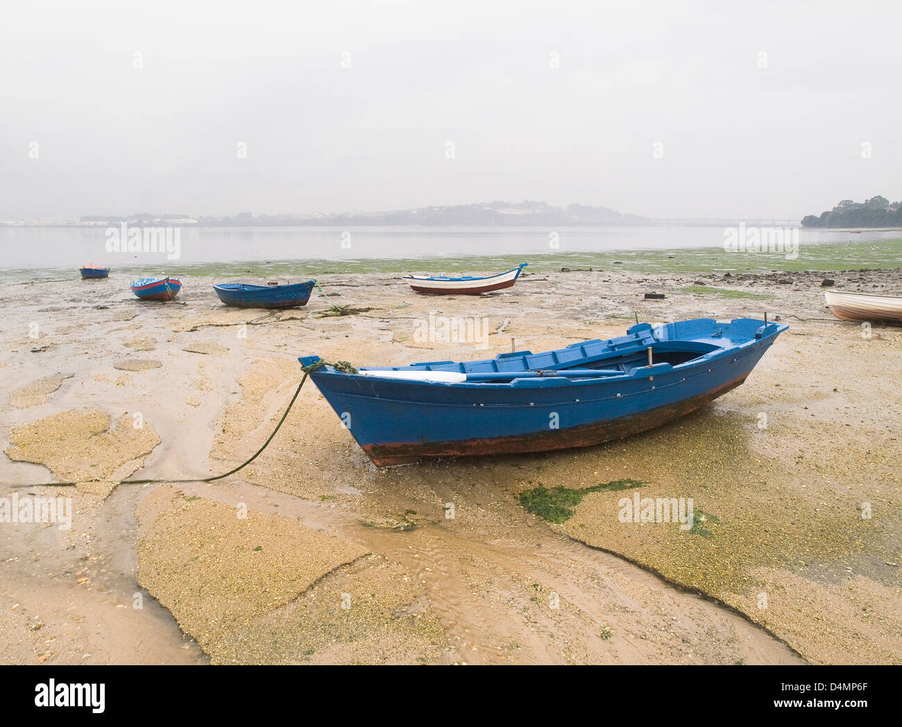 Set of boats stranded on the sand at low tide. The picture was taken in Ferrol, Galicia, Spain. Stock Photo