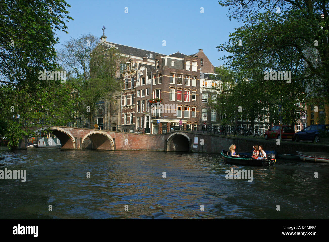 The Netherlands Holland Amsterdam Keizersgracht Churh Reguliersgracht Canal Boat Girls Bridges Stock Photo