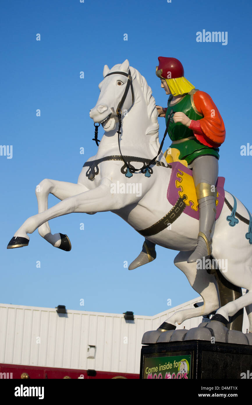colourfully dressed man on white horse rearing up statue Stock Photo
