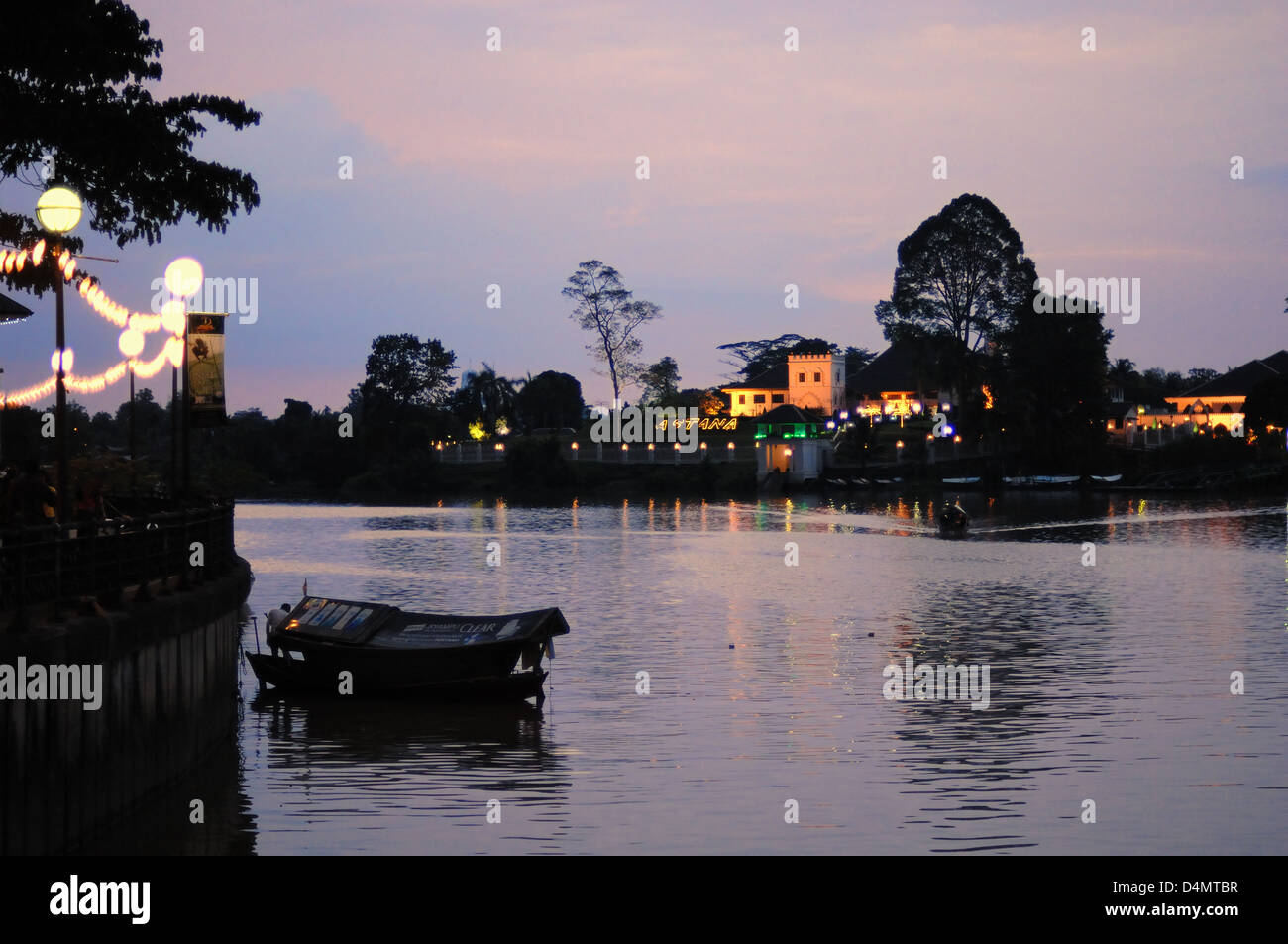 Dusk Skyline on Sarawak River and Astana Governor's Residence Kuching Sarawak Borneo Malaysia Stock Photo