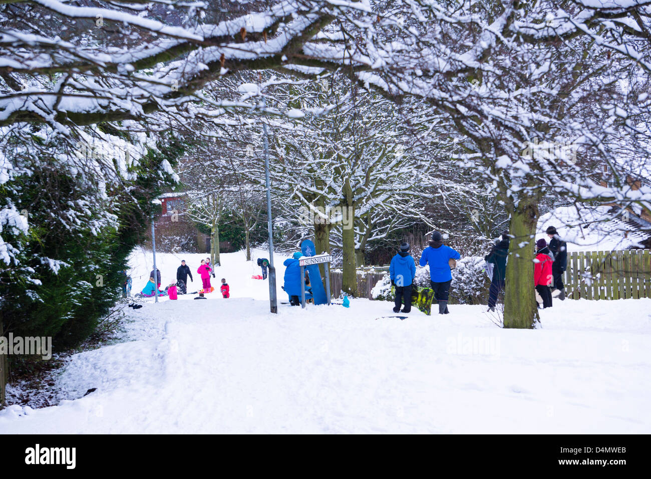 Families take the opportunity to venture for some quality play time in the snow Stock Photo