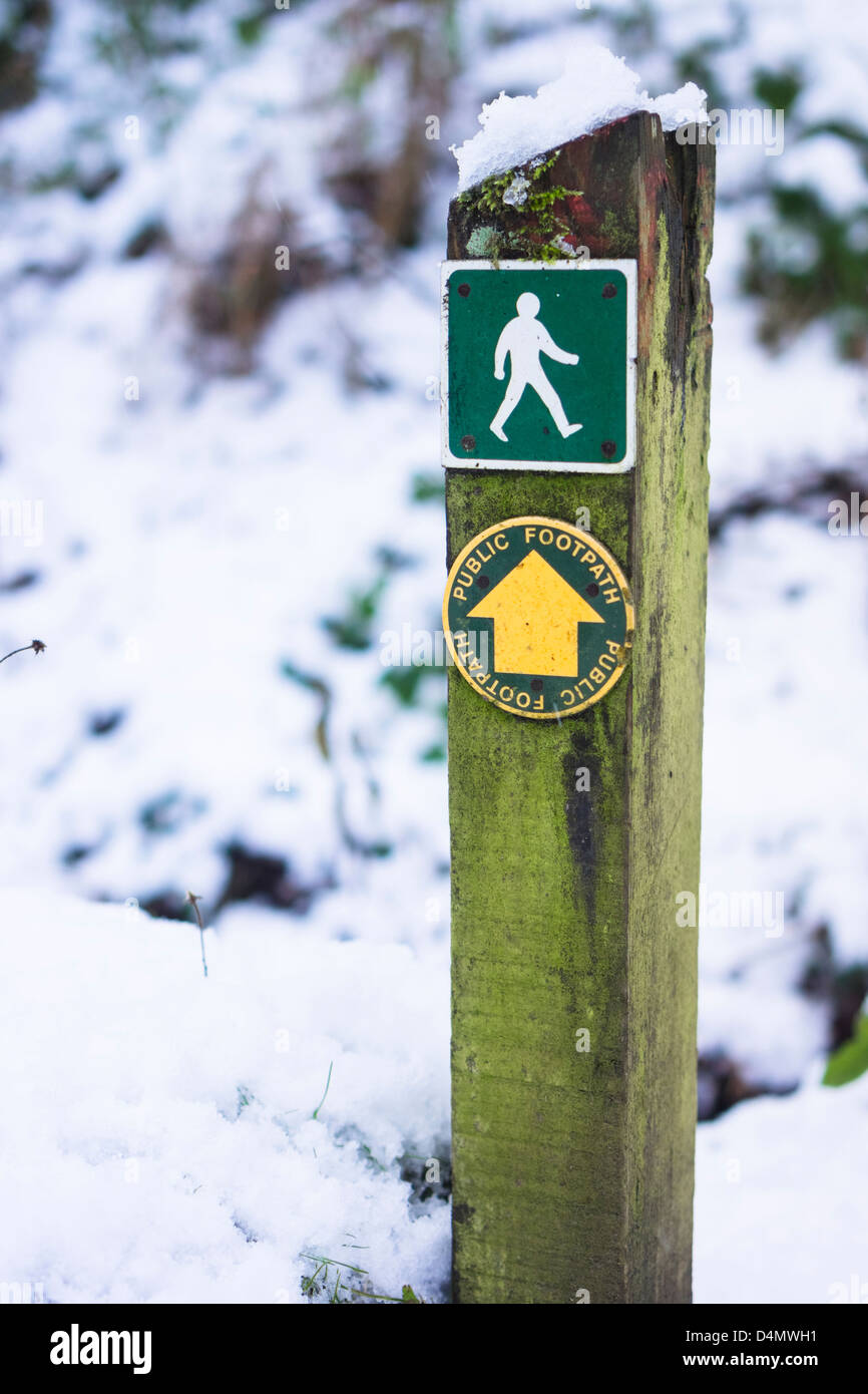 Woodland footpath sign in winter snow. Stock Photo