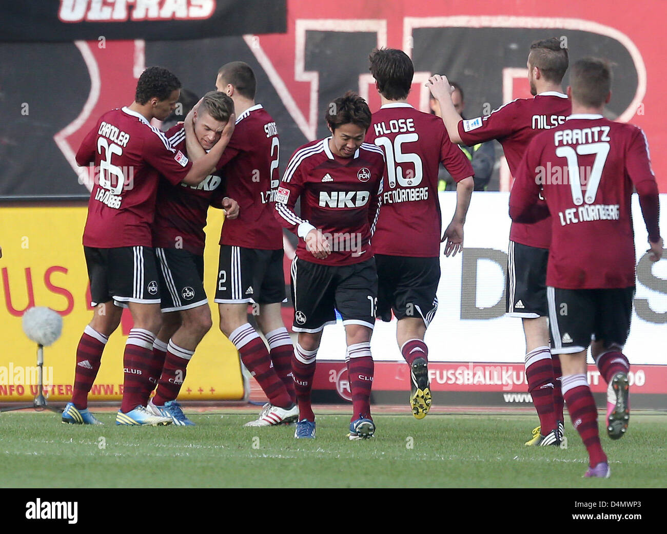 Nuremberg's Alexander Esswein (2-L) celebrates his 2-0 goal with his team mates Timothy Chandler (L-R), Timmy Simons, Hiroshi Kiyotake, Timm Klose, Per Nielsson and Mike Frantz  during the German Bundesliga soccer match between 1. FC Nuremberg and FC Schalke 04 at Grundig Stadium in Nuremberg, Germany, 16 March 2013. Photo: DANIEL KARMANN  (ATTENTION: EMBARGO CONDITIONS! The DFL permits the further utilisation of up to 15 pictures only (no sequential pictures or video-similar series of pictures allowed) via the internet and online media during the match (including halftime), taken from inside  Stock Photo
