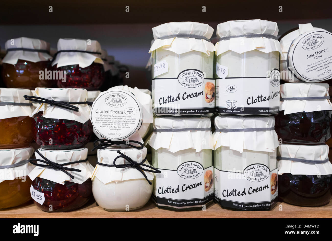 Jars Of Cottage Delight Jam And Clotted Cream On A Shelf Stock