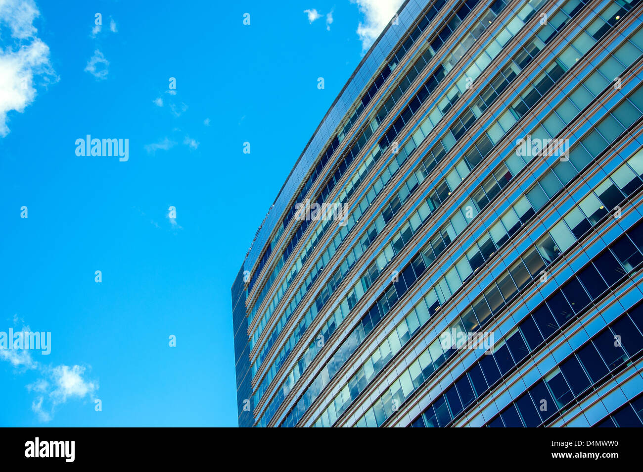 Details of a blue tinted office building against a beautiful blue sky. Stock Photo