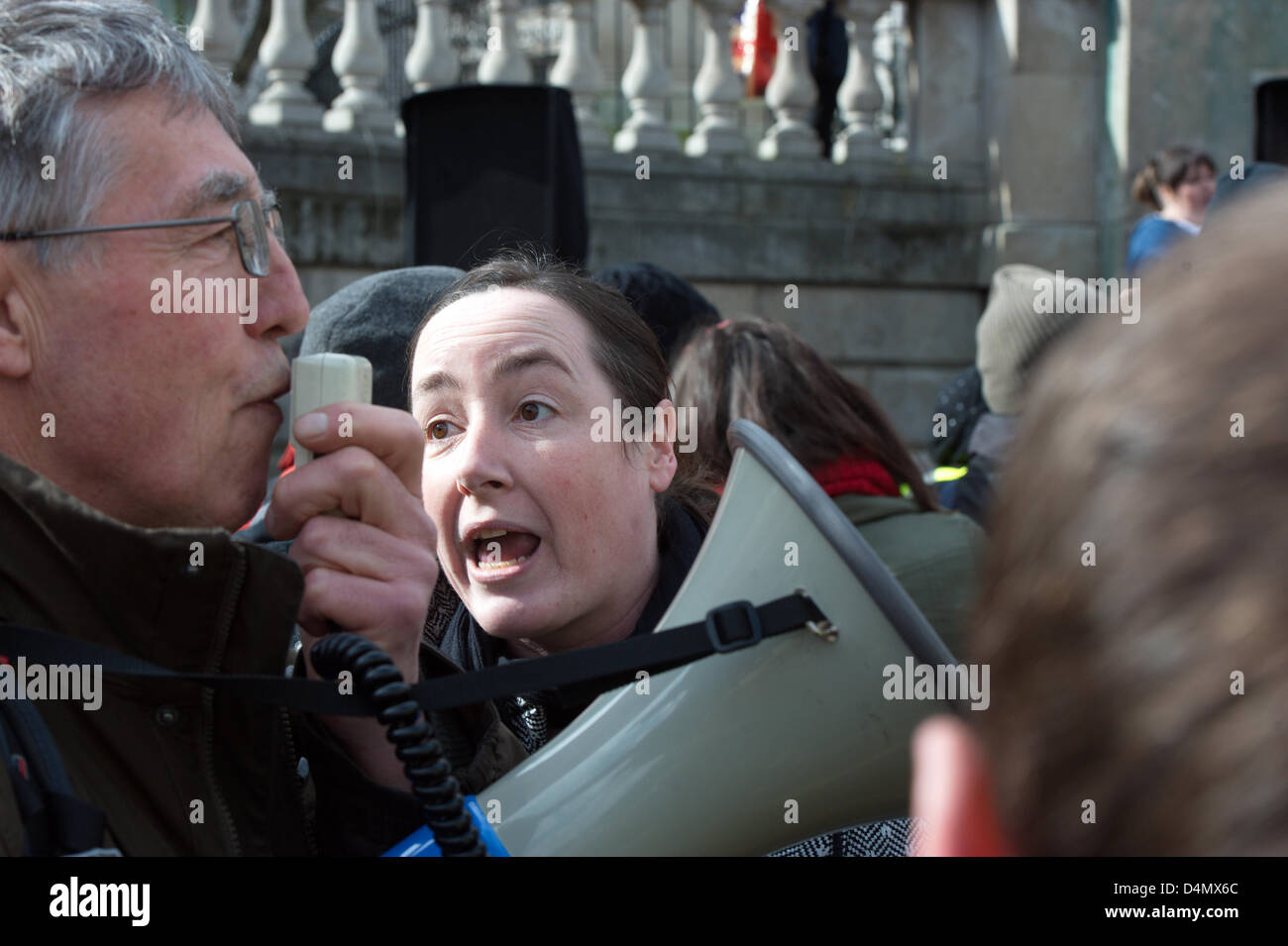 Liverpool, UK. Saturday 16th March 2013. Labour Party supporter tries to silence a dissenter in the crowd. As part of nationwide protests, campaigners gathered in Liverpool city centre to demonstrate against a new 'bedroom tax' that will cut benefits to people with a spare room. Credit: David Colbran/Alamy Live News Stock Photo