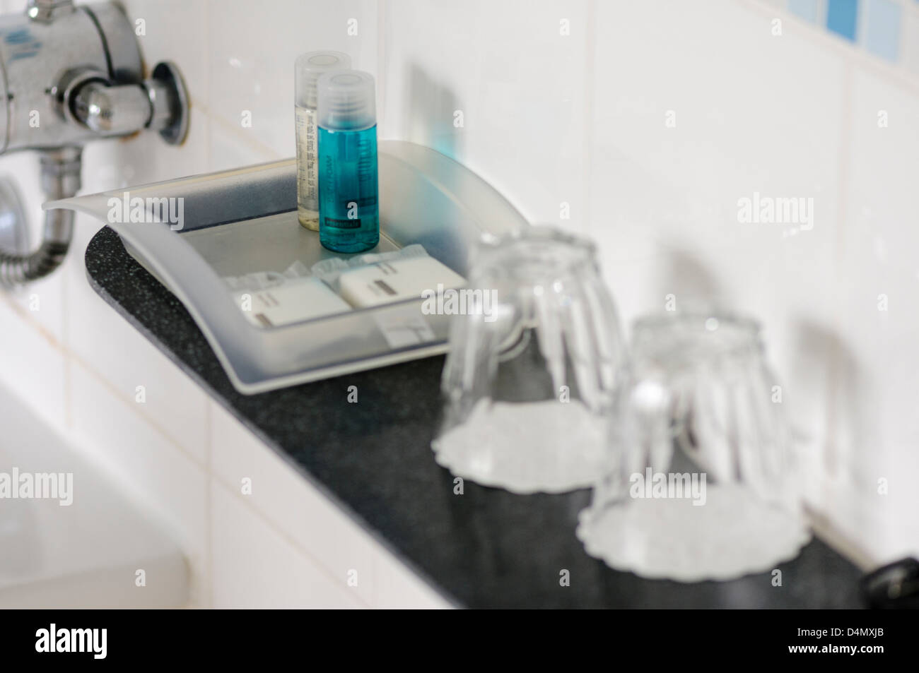 Toiletries and classes in the bathroom of a hotel bedroom. Stock Photo