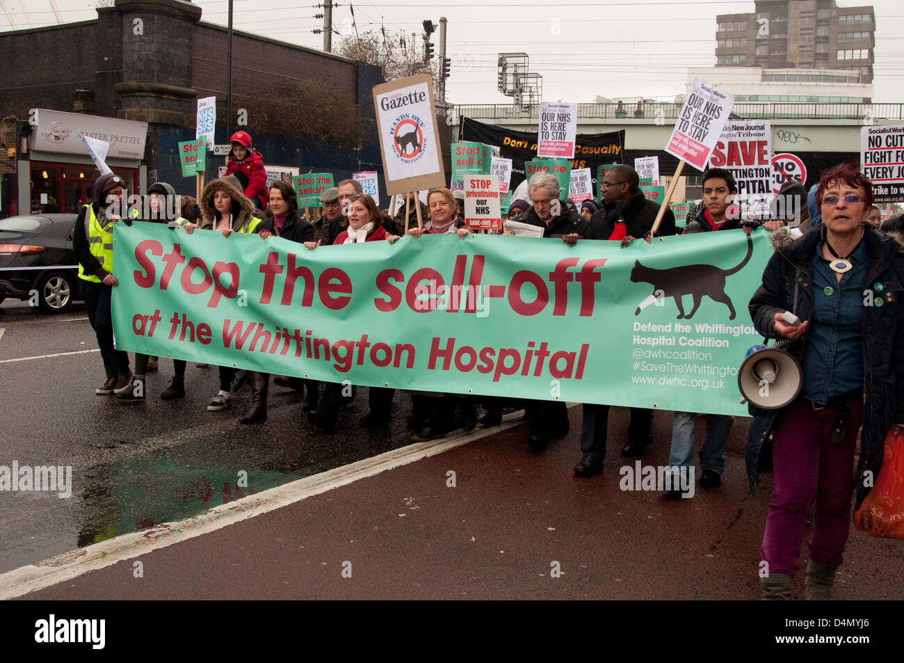 London UK, 16th March 2013. Thousands of people campaigning to stop the cuts at the Whittington Hospital march through an overcast, rainy Islington before arriving at the Hospital itself. The board of the Whittington Hospital Trust have controversial plans for budget cuts, which include selling off one third of the site, closing beds and services and losing over five hundred jobs. Stock Photo