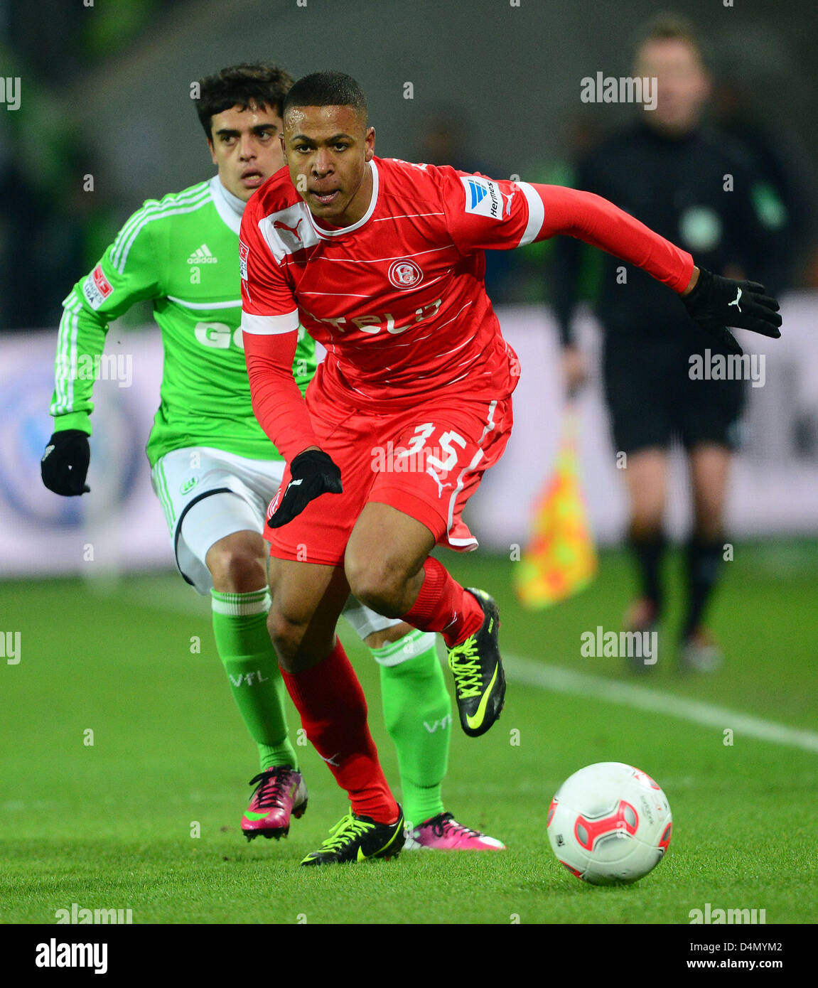Wolfsburgs' Fagner and Duesseldorfs' Mathis Bolly vie for the ball during the match VfL Wolfsburg - Fortuna Duesseldorf in the Volkswagen-Arena in Wolfsburg, Germany, 15 March 2013. Photo: Peter Steffen  (ATTENTION: EMBARGO CONDITIONS! The DFL permits the further utilisation of up to 15 pictures only (no sequential pictures or video-similar series of pictures allowed) via the internet and online media during the match (including halftime), taken from inside the stadium and/or prior to the start of the match. The DFL permits the unrestricted transmission of digitised recordings during the match Stock Photo