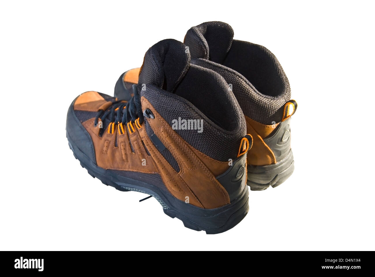 Hiking boots in the sunlight on a white background. Stock Photo