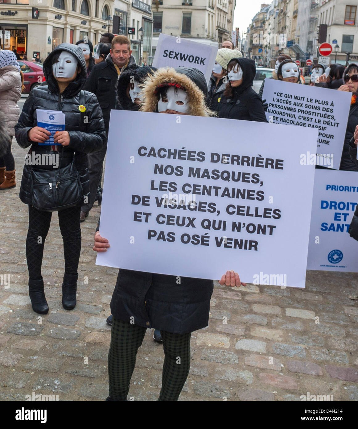 Paris, France, French N.G.O's protesting Against Anti-Prostitution Law  Forbidding passive soliciting for Clients, Chinese Prostitute in Mask,  Migrants Holding Protest Signs on Street "Hidden By Our Masks, Hundreds of  Faces, and those