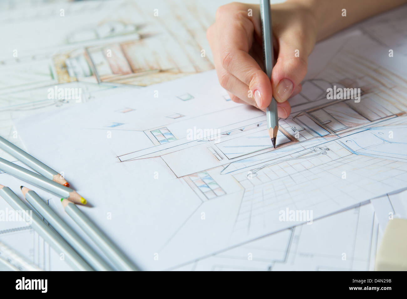 Interior designer works on a hand drawing sketch using color pencils, rule and rubber Stock Photo