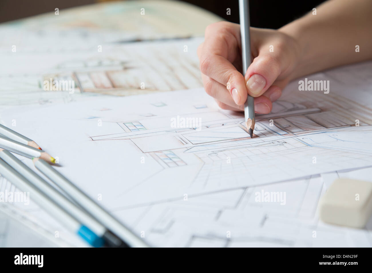Interior designer works on a hand drawing sketch using color pencils ...