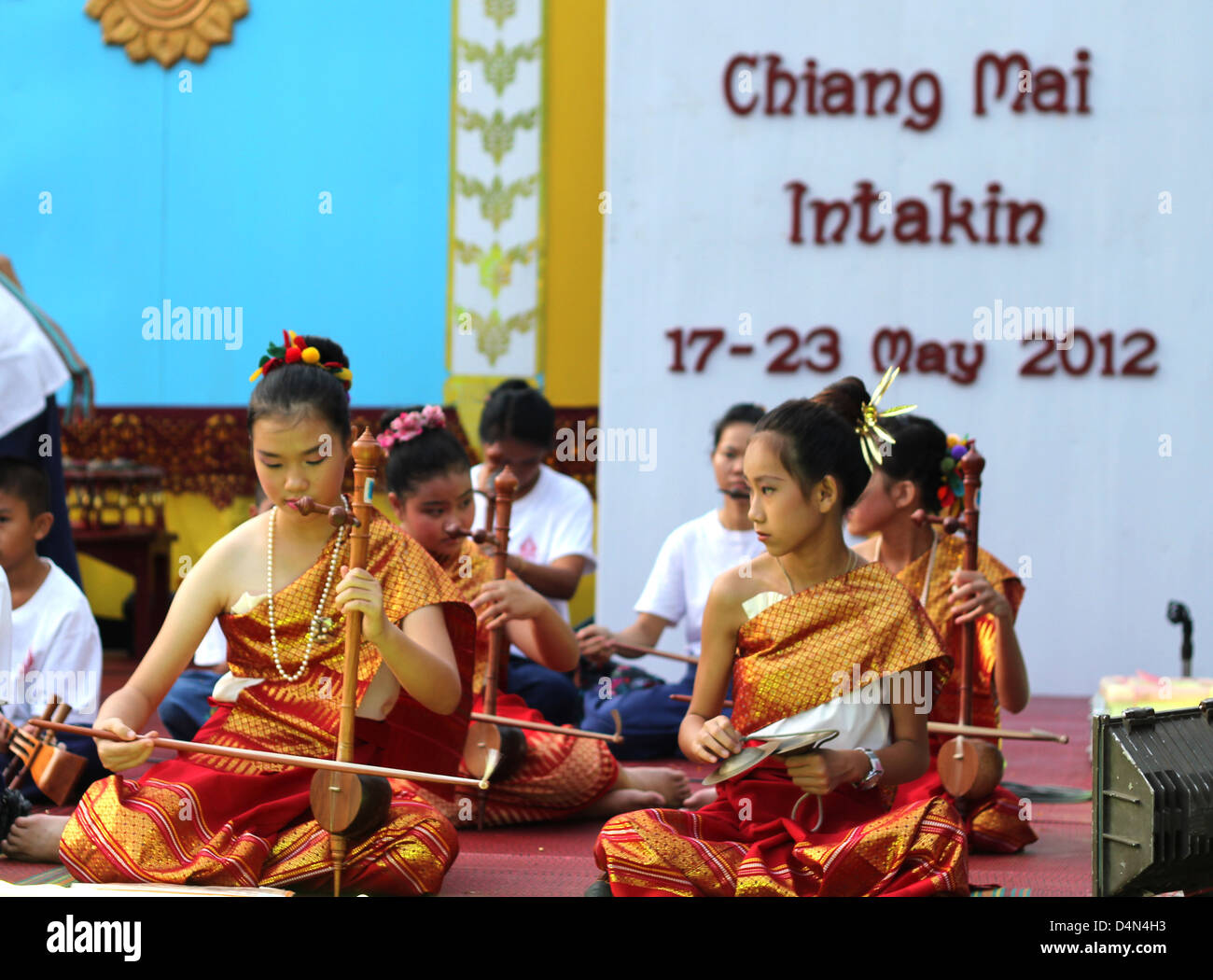 Young girls playing khrueang sai in front of a temple Chedi Luang during Inthakhin festival in Chiang Mai, Thailand Stock Photo