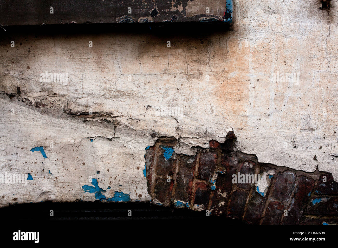 Damaged wall with paint and bricks visible underneath Stock Photo Alamy
