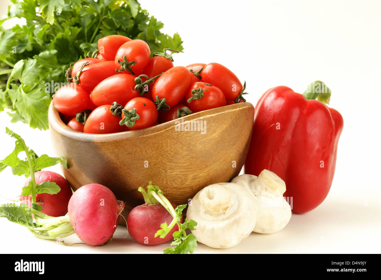 cherry tomatoes, radishes, peppers and parsley - assorted vegetables Stock Photo