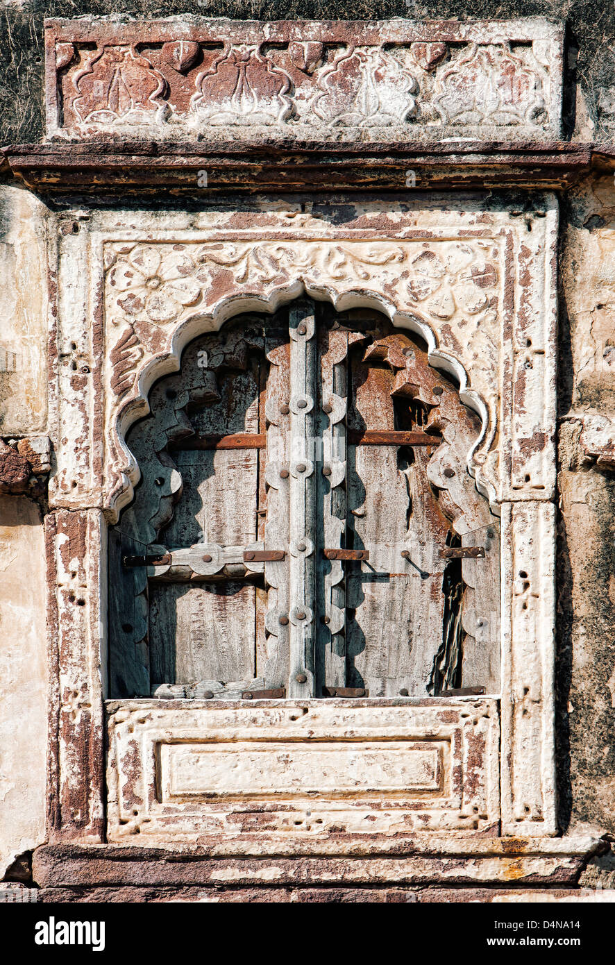 Old window and wooden shutters with stone-carved architraves, background. India, Asia Stock Photo