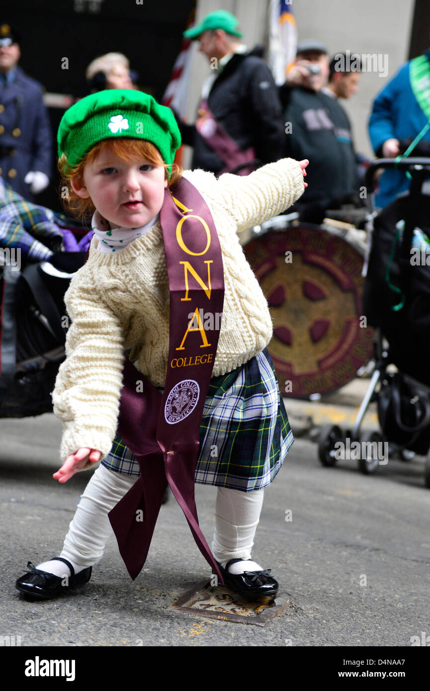 March 16, 2013 - New York, NY, U.S. - Wee GRACE TAYLOR, 20-month-old redhead girl, dances Irish jig before marching in 252nd annual NYC St. Patrick’s Day Parade with the Iona College, New Rochelle, NY, group. Marchers showed their Irish pride, as they march up Fifth Avenue. Stock Photo