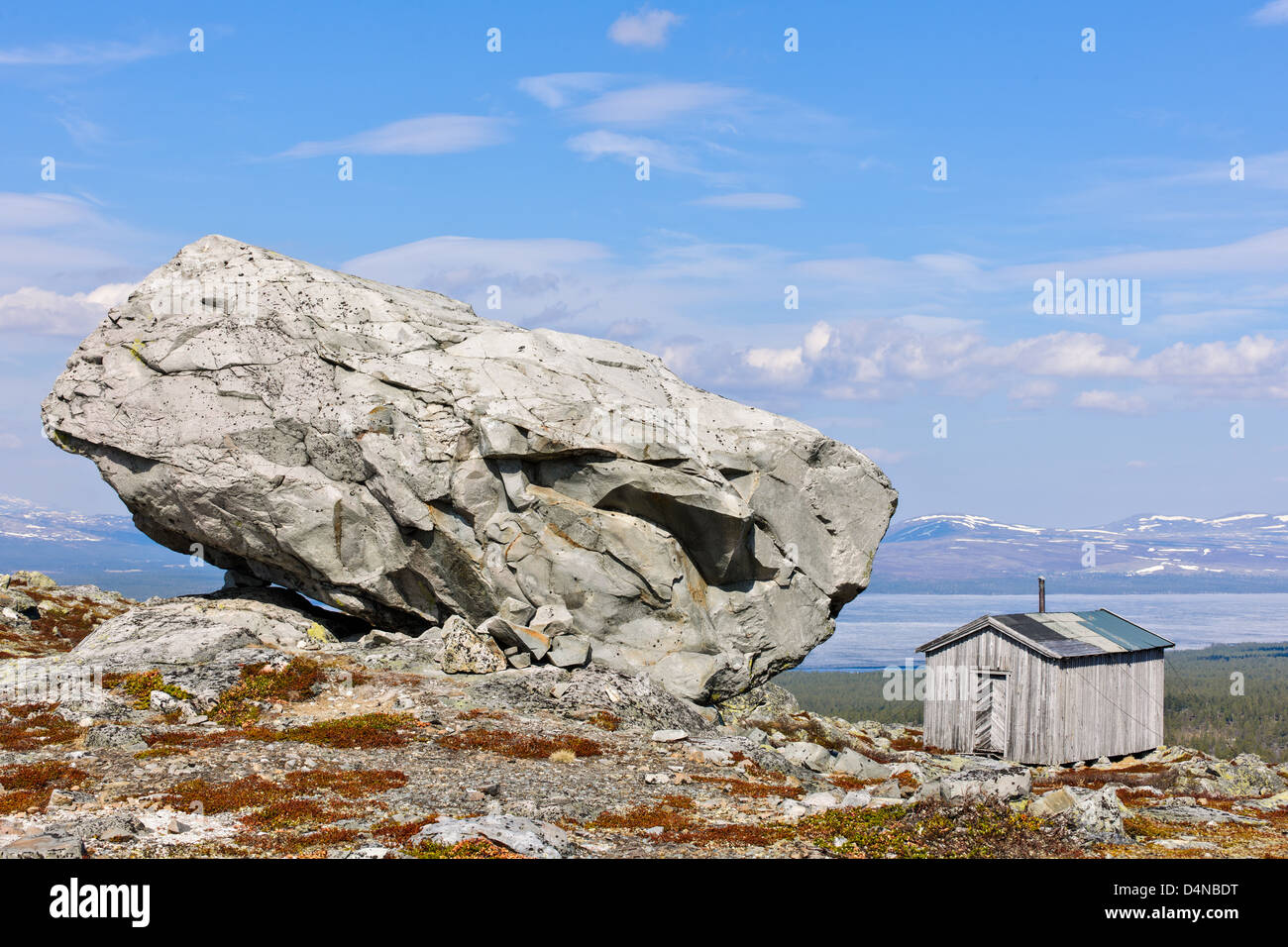 Remote hut by large rock, Hedmark fylke, Norway, Europe Stock Photo