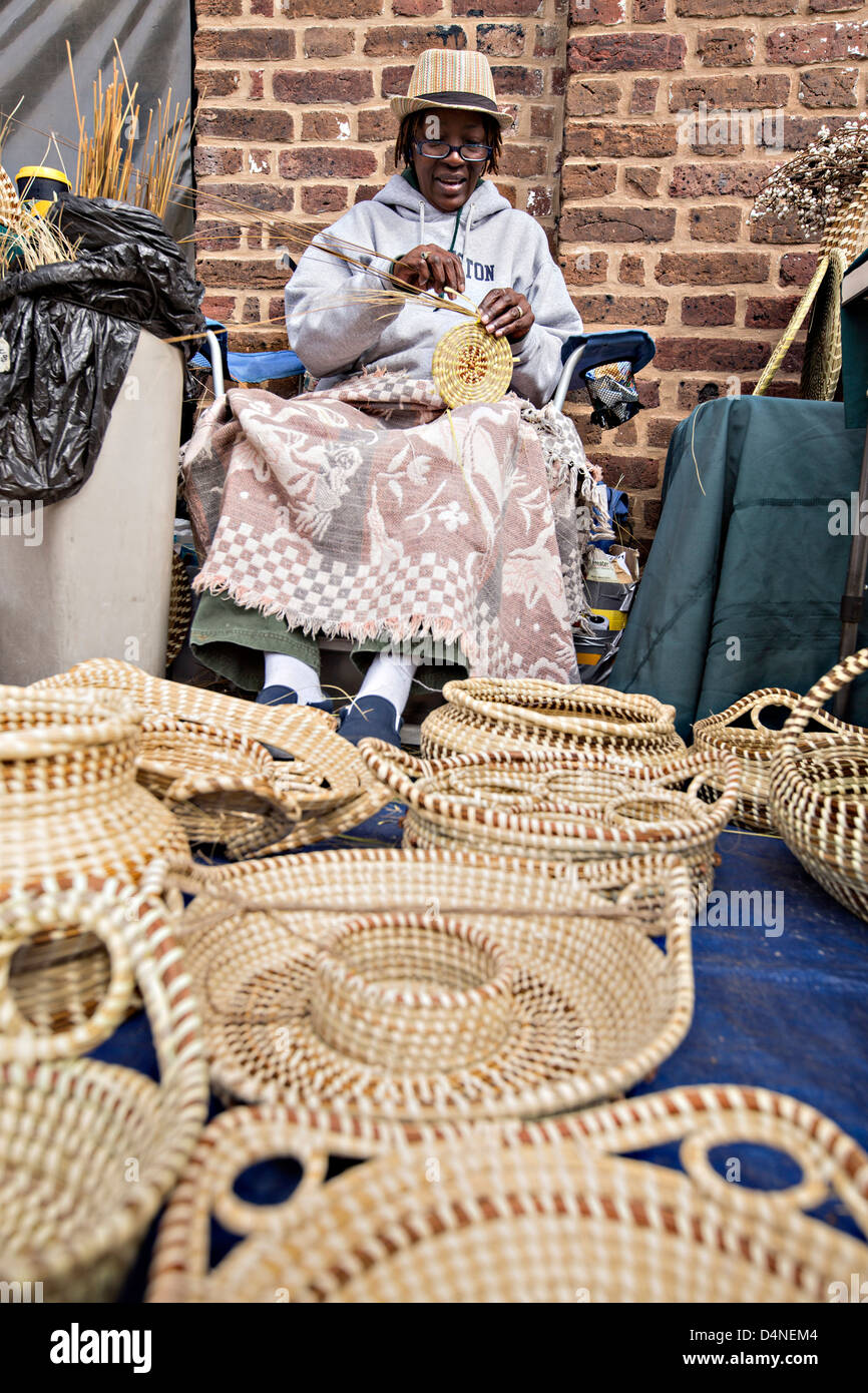 Gullah woman weaving sweetgrass baskets at the Historic Charleston City